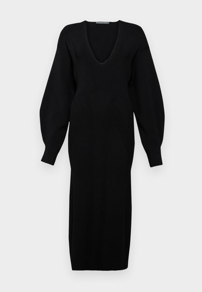 Černé pletené šaty s hlubokým výstřihem do V, dlouhými objemnými rukávy a detaily textura na živůtku.