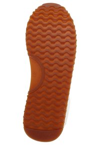 Rubber shoe sole with textured wave pattern, in orange color, featuring a circular logo detail and a rounded toe shape.