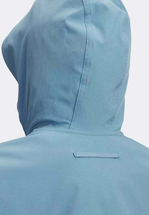 Light blue hooded jacket seen from the back, showing seam details and a small horizontal fabric loop near the neck.