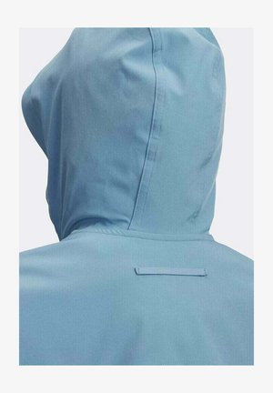 Veste à capuche bleu clair vue de dos, montrant les détails des coutures et une petite boucle en tissu horizontale près du cou.
