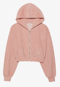Haut de hoodie zippé coupé en velours côtelé rose doux. Présente une capuche et deux poches avant. Manches et ourlet côtelés avec un motif à rayures verticales.