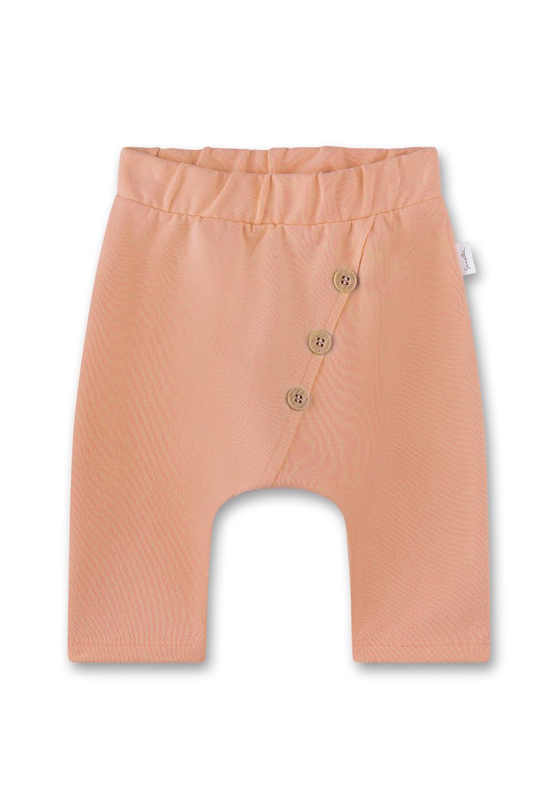 Pfirsichfarbene Babyhose aus weichem Stoff, mit einem breiten elastischen Bund und drei dekorativen Holzknöpfen an der Seite.
