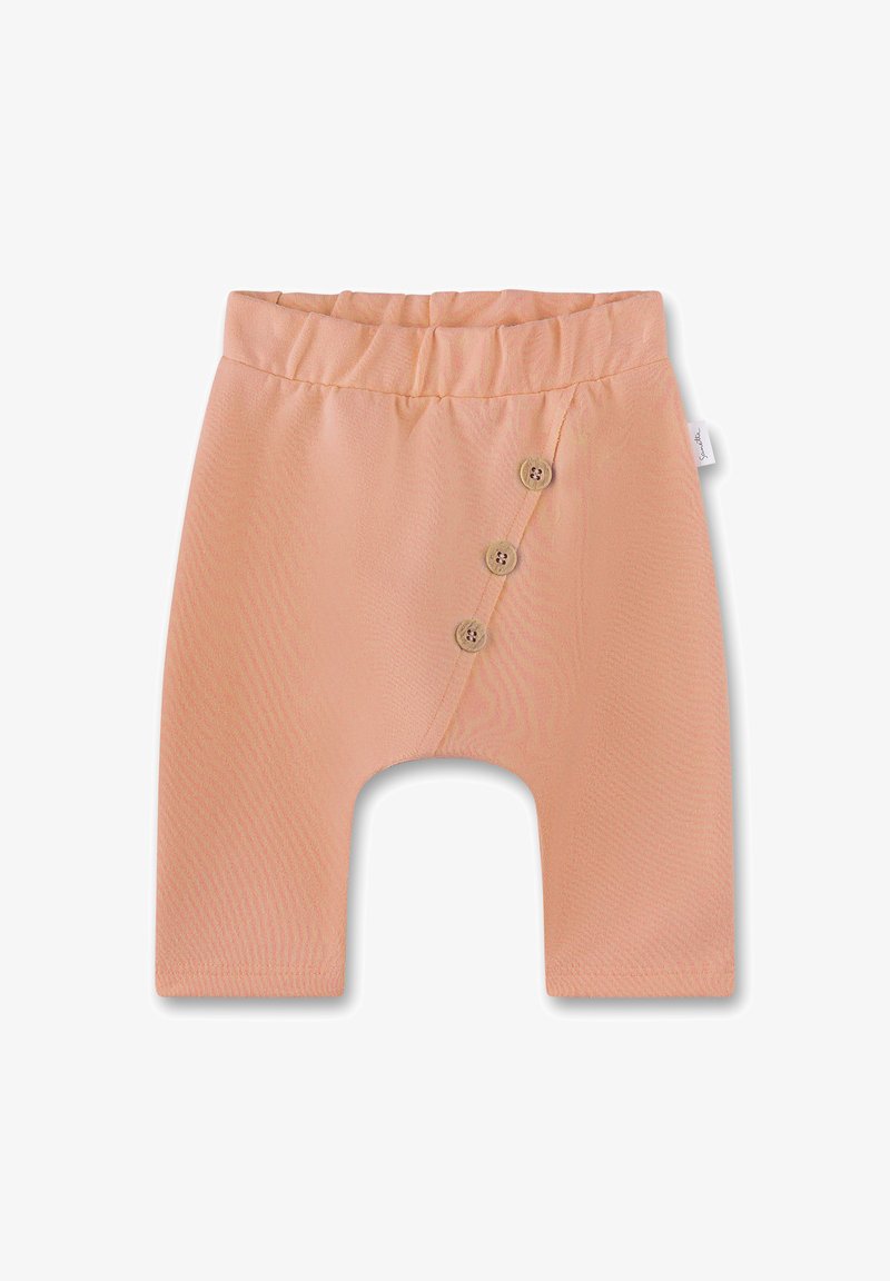 Pfirsichfarbene Babyhose aus weichem Stoff, mit einem breiten elastischen Bund und drei dekorativen Holzknöpfen an der Seite.