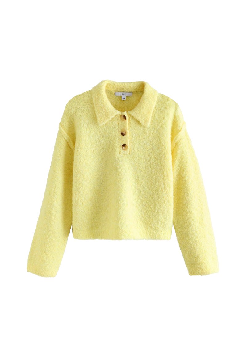 Żółty krótki sweter z miękkiej, teksturowanej tkaniny, z kołnierzykiem i trzema drewnianymi guzikami z przodu. Długie rękawy, luźny krój.