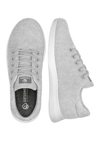 Gray knitted sneakers with a textured upper, flat laces, a white rubber sole, and a logo tag on the tongue.