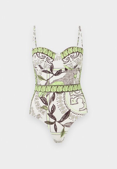 Maillot de bain une pièce blanc avec fines bretelles, présentant un motif de feuilles vertes et d'oiseaux détaillés ainsi que des accents décoratifs marrons.