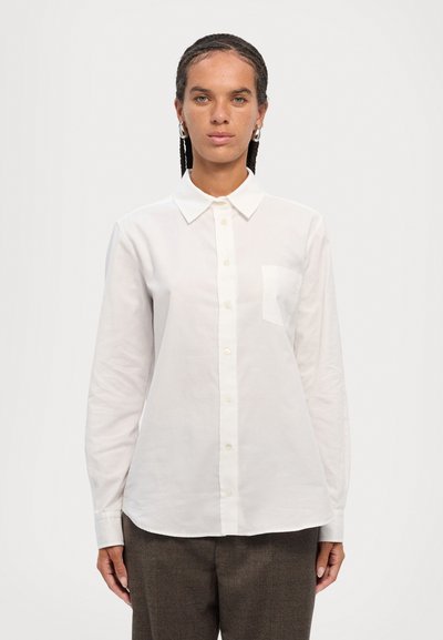 White button-up shirt with a collar, long sleeves, and a chest pocket. Fabric appears smooth with a subtle sheen. Simple and classic design.