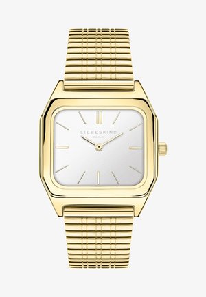 Kvadratisk guldtonet ur med poleret overflade og børstet sølvskive. Har timemarkører og et tekstureret metalarmbånd.