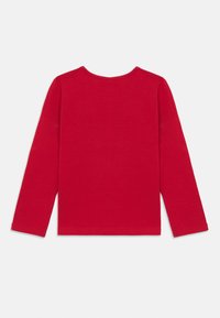 Red long-sleeve t-shirt made of soft cotton, featuring a simple rounded neckline and straight hem, with unembellished smooth texture.