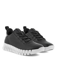 Sorte lær sneakers med strukturert overflate og hvit gummisåle med et sammenflettet design. Skoene har lisser og en løkke bak.