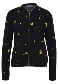 Černá bunda na zip s květinovým vzorem a žlutými a zelenými akcenty. Lehce pratelné látky, dlouhé rukávy a kulatý výstřih.