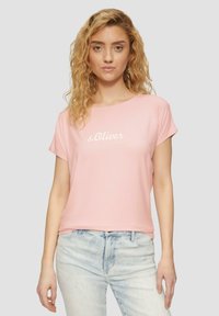 T-shirt rose à manches courtes avec col rond, présentant le texte blanc "s.Oliver". Tissu doux et coupe décontractée avec bords de manches retroussés.
