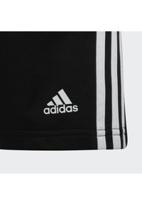 Shorts sportivi neri realizzati in tessuto con un design a tre strisce bianche e logo sul lato sinistro in basso. Texture liscia e forma aderente.