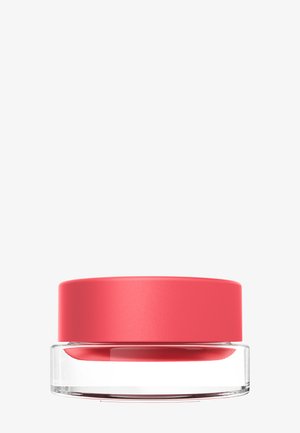 Small clear cosmetic jar with a smooth, matte coral-colored lid against a white background.