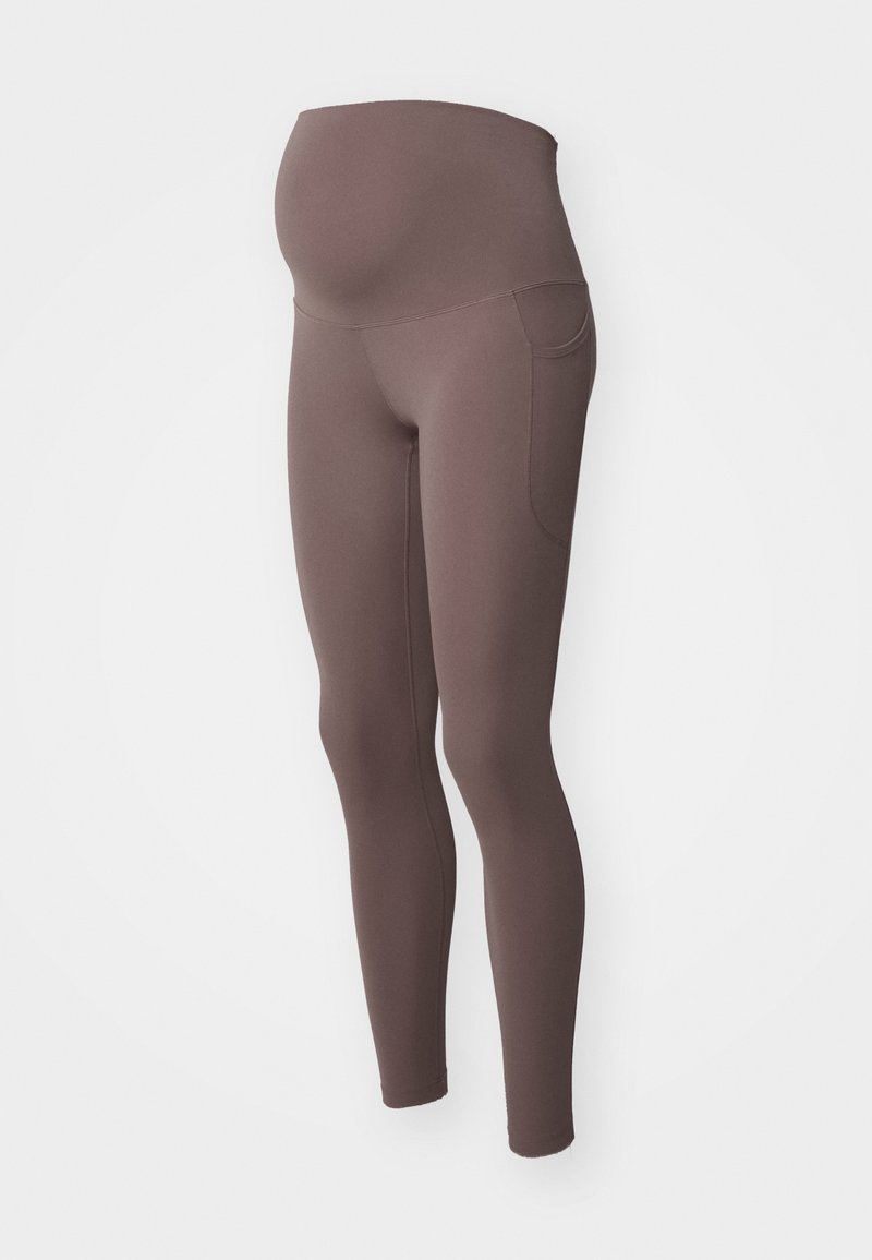 Schwangerschaftsleggings in gedämpftem Braun mit hoch elastischem Bund, der den schwangeren Bauch bedeckt. Sie verfügen über Seitentaschen und eng zulaufende Beine.