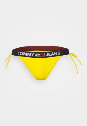 Parte inferiore di bikini gialla con logo del marchio nero e rosso sulla cintura. Caratterizzata da dettagli laterali con lacci e un materiale morbido e elastico. Adatta per costumi da bagno.