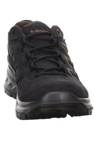 Dark navy hiking shoe with a suede and mesh upper, sturdy rubber sole, and prominent lacing system. Features brown brand logo accents.