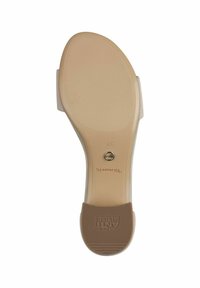 Beige syntetisk sula med lätt båge, texturerad gummibotten, Tom's logga präglad, liten rund metall accent nära hälen, storlek 37.