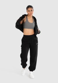 Smilodox Teplákové kalhoty - schwarz