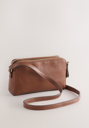 Brown leather crossbody bag with two zippered compartments, a textured surface, and a thin, adjustable strap. Gold hardware accents.