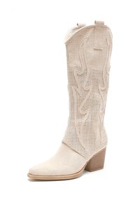 Bota vaquera de ante perforado beige con punta afilada y tacón ancho; presenta costuras decorativas en un patrón de llamas y un diseño de media pantorrilla.
