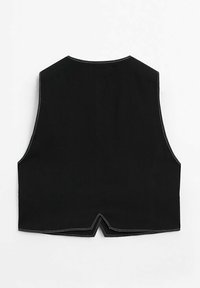 Schwarzes ärmelloses Vest mit spitzem Saum, das kontrastierende weiße Nähte entlang der Kanten und eine glatte Baumwolltextur aufweist.