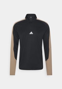 Black long-sleeve athletic top with a quarter zip, featuring tan accents on the shoulders and a white Adidas logo on the chest.