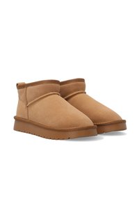 Pair of short, tan suede winter boots with fleece lining and brown rubber soles, shown on a white background.