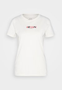 Vit t-shirt med kort ärm och rund halsringning, med "ARMANI EXCHANGE" broderat i svart och rött centrerat på bröstet.