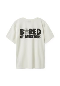 Cream cotton t-shirt featuring a large black graphic text on the back: "BORED OF DIRECTORS" with an illustrated character wearing a cap.