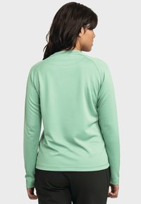 Langärmliges, mintgrünes Sportshirt mit glatter Textur und rundem Halsausschnitt. Verfügt über Raglanärmel und eine figurbetonte Silhouette.