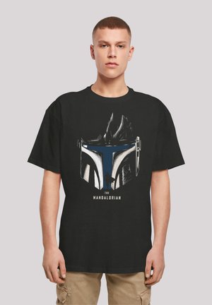 Black t-shirt featuring a graphic of a helmet, highlighting blue and white accents with the text "THE MANDALORIAN" underneath.