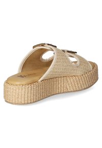 Beige woven platform sandals with cutouts, featuring a textured sole and smooth insole. Decorative hardware accents on the upper.