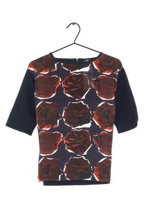Short-sleeved top with a dark navy base, featuring red rose patterns and a rounded neckline. Made of soft, lightweight fabric.