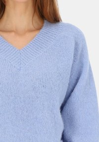 Jasnoniebieski sweter z dzianiny z dekoltem w serek, prążkowanymi mankietami i miękką fakturą, podkreślający komfort i swobodny styl.