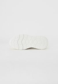 White athletic shoe sole, made of rubber with a textured pattern for grip. Features rounded edges and defined tread lines.