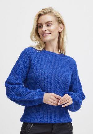 Blue knitted sweater with a textured design, crew neckline, and slightly puffed sleeves. The fabric appears soft and warm.