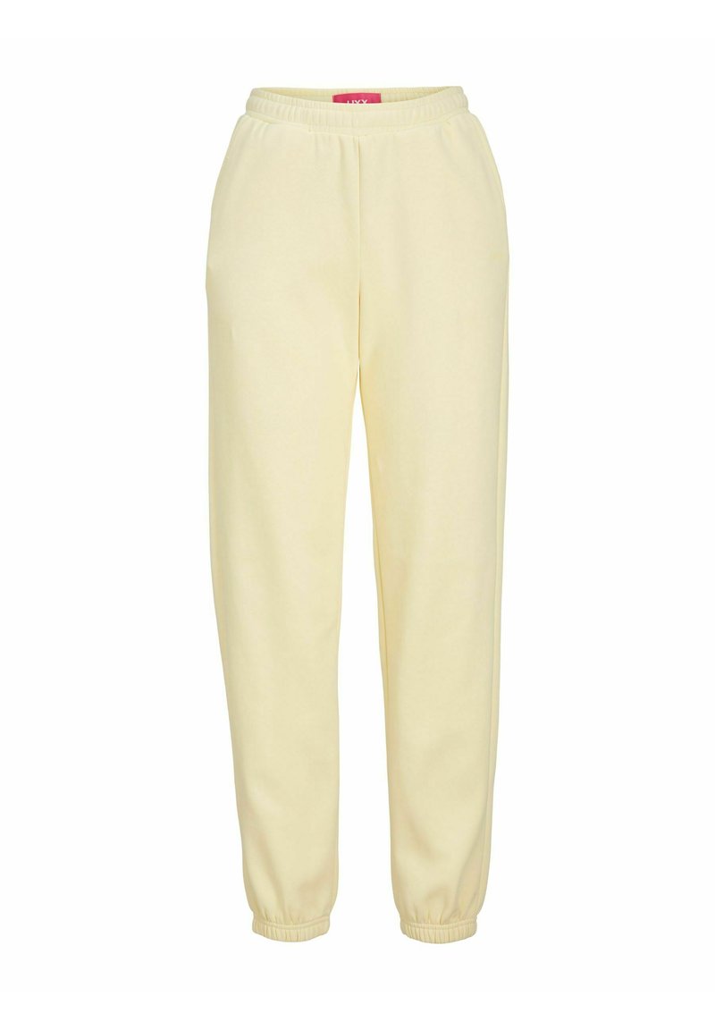 Pantalones deportivos amarillos claros con cintura y puños elásticos, hechos de una tela suave. Sin bolsillos ni patrones distintivos.