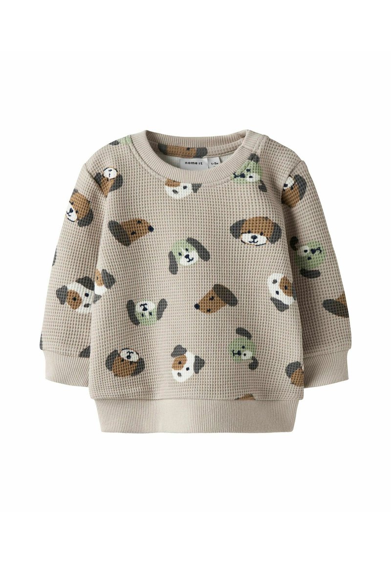 Felpa beige in tessuto a nido d'ape con motivi colorati di cani in varie posizioni. Polsini e orlo a coste con scollo rotondo.