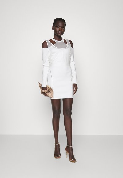 Λευκό φόρεμα off-the-shoulder με υφή, εφαρμοστή σχεδίαση και διακριτική ραφή. Διακοσμημένο με μια χρυσή λουρί και μια υφασμάτινη τσάντα.