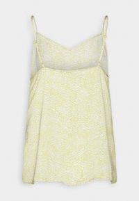 Camisole sans manches à motif jaune clair et blanc avec bretelles fines réglables et encolure en V, présentée à plat sur un fond neutre.