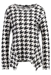 Pull en motif pied-de-poule noir et blanc, avec des manches longues, un col large et un design d'ourlet asymétrique. Texture douce.