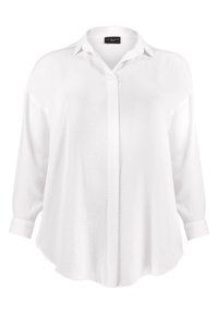 White long-sleeve blouse made of lightweight fabric, featuring a pointed collar, button placket, and a relaxed, rounded hemline.