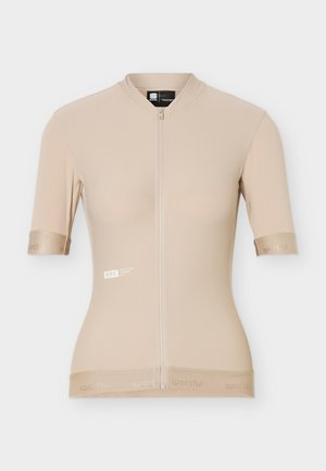 Camiseta de ciclismo beige de manga corta con cremallera frontal, logo sutil en el pecho y puños y dobladillo elásticos con marca.