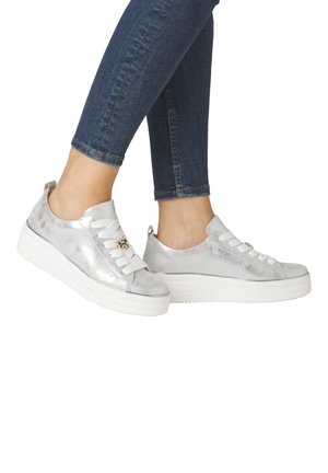 Silver metallic sneakers with white laces, featuring a round toe and a thick white platform sole. Subtle texture and decorative accents.