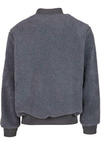 Giacca bomber grigia fuzzy realizzata in pile testurizzato, con polsini e orlo a costine, scollatura rotonda e silhouette cropped.