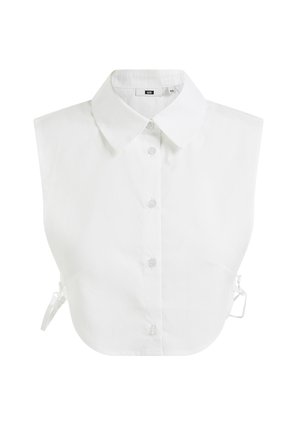 White sleeveless shirt with a pointed collar, front button closure, and adjustable ties on the sides. Made from smooth cotton fabric.