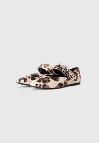 Pair of flat shoes with pointed toes, leopard print fabric, and wide straps with silver buckles across the top.