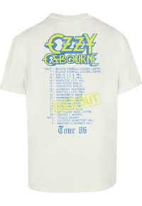 White cotton t-shirt featuring a colorful graphic design with "Ozzy Osbourne" text and a tour schedule from 1986, including "SOLD OUT" stamp.