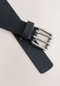 Black leather belt with a textured finish, featuring a silver rectangular buckle and multiple adjustment holes. Flat tip design.